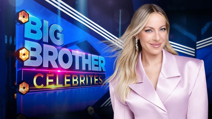 Marie-Mai portant un veston rose, cheveux au vent, près du logo de Big Brother Célébrités sur le plateau de l'émission de Noovo et Crave